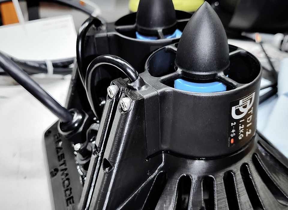 Twin ducted-fan thrust units with blue prop cones, the BeastMode Development claw logo molded into the printed housing.