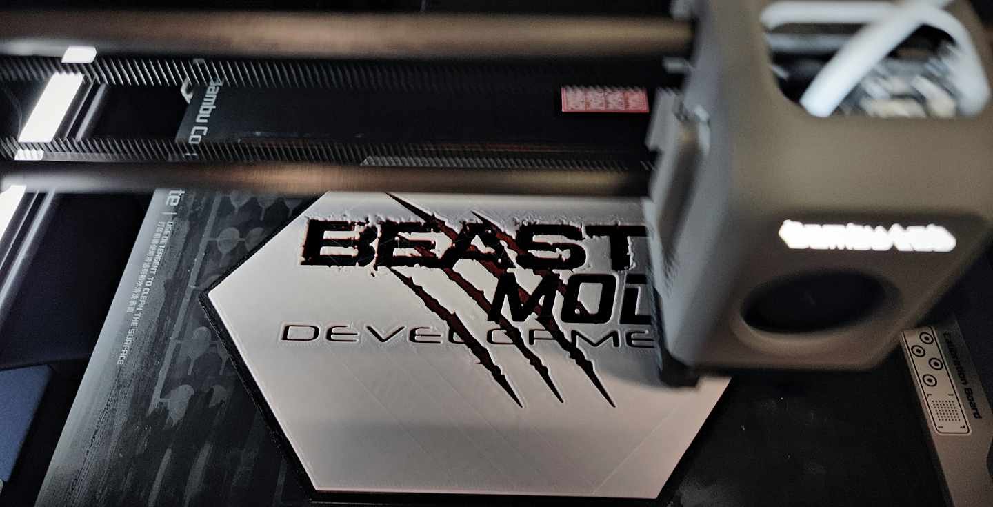 Laser engraver cutting the BeastMode Development claw logo into signage material, control panel glowing in the dark shop.